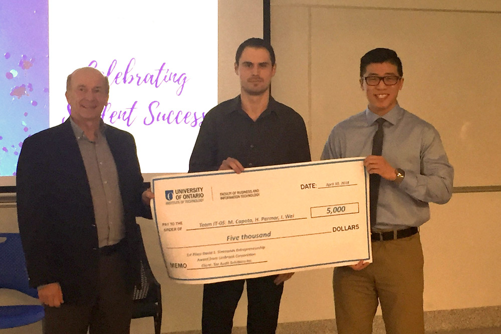 Capstone team members Marcu Capota (centre) and Ian Wei (right), with Stephen Rose, FBIT Associate Dean - External and Associate Teaching Professor, receive the first-place Lenbrook Award for their work with Tax Audit Solutions Inc.