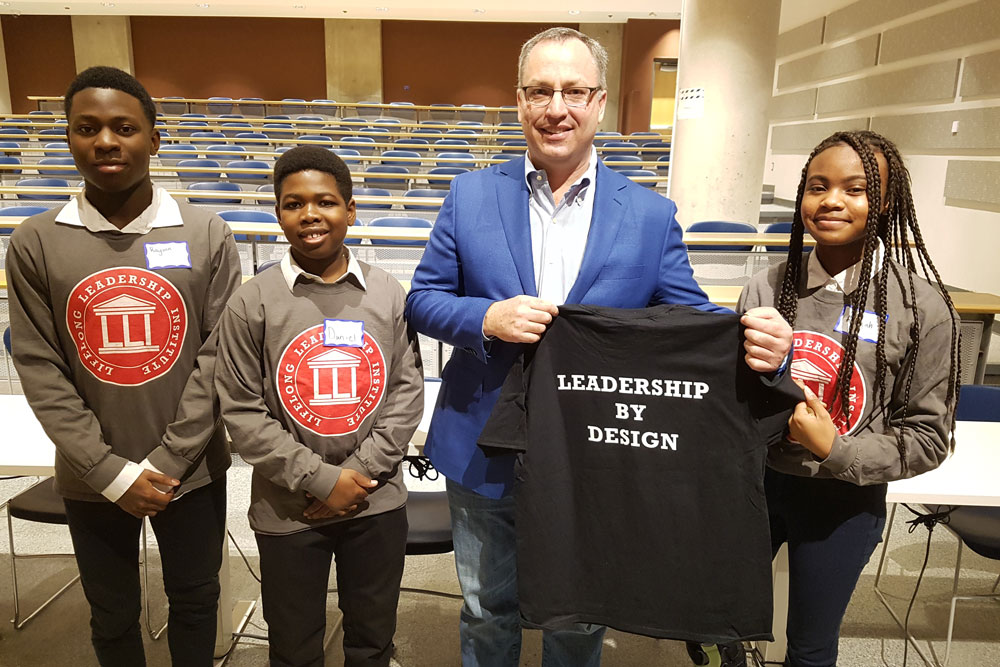 Steven Murphy, PhD, President and Vice-Chancellor, University of Ontario Institute of Technology, receives a gift from Leadership By Design students.