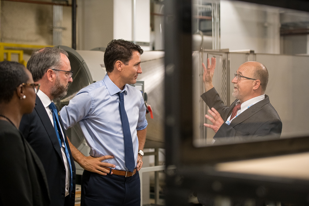 Prime Minister Justin Trudeau, listening to John Komar, Director of Engineering and Operations, ACE explaining how the new Moving Ground Plane connects to the ACE Enhancement Project.