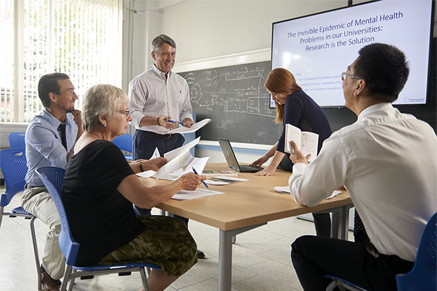 Dr. Pierre Côté (centre, standing) is the university’s Canada Research Chair in Disability Prevention and Rehabilitation.