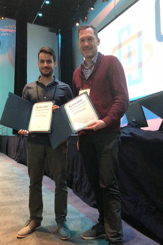 Honourable Mention Award for Best Paper presented to Rafael Veras (left) and Christopher Collins of Ontario Tech University's Faculty of Science (May 6, 2019).