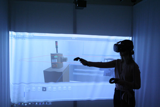 Nuclear Engineering student demonstrating a virtual reality radiation field simulator in the Faculty of Energy Systems and Nuclear Science's SIGMA Laboratory.