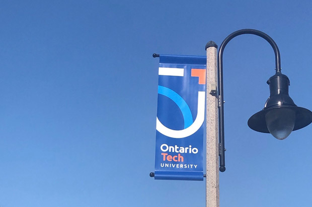 New Ontario Tech University banner on street light along Athol Street in downtown Oshawa.