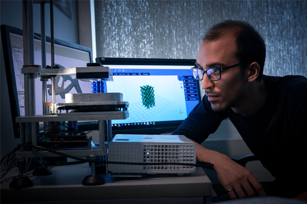 Manufacturing Engineering PhD student Cody Berry working on research in the Faculty of Engineering and Applied Science's Advanced Coordinate Metrology Laboratory at Ontario Tech University. 