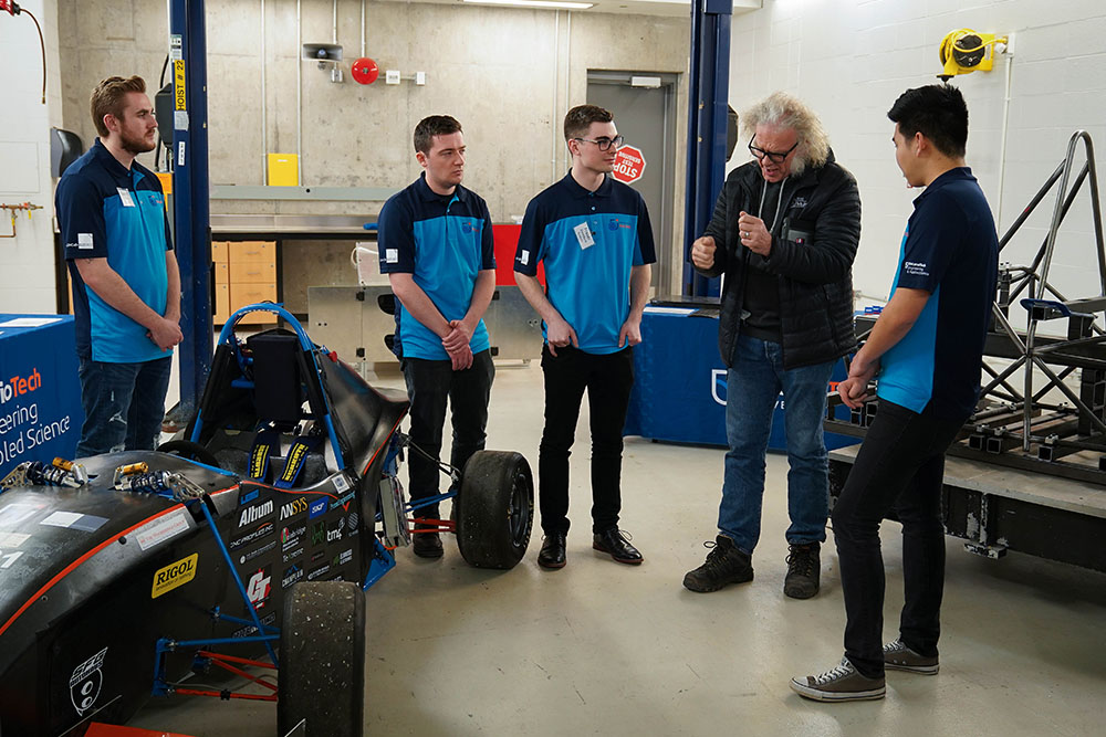 Larry Holt, Chief Technical Officer, Multimatic Inc. (second from right) with members of the Ontario Tech Racing team.