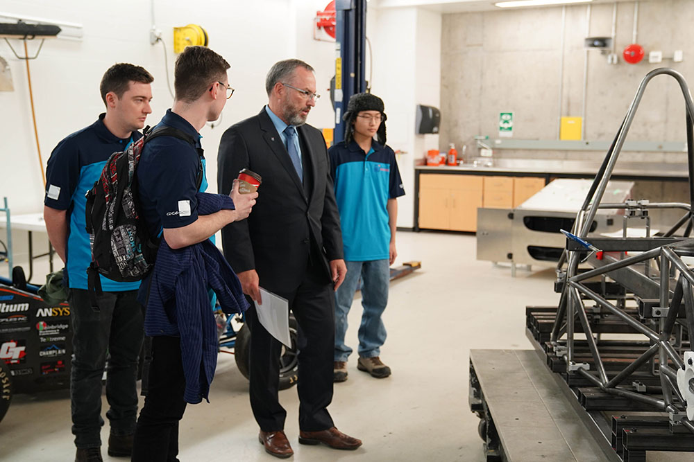 Dr. Steven Murphy, President and Vice-Chancellor, Ontario Tech University (centre) meeting with members of the Ontario Tech Racing team.