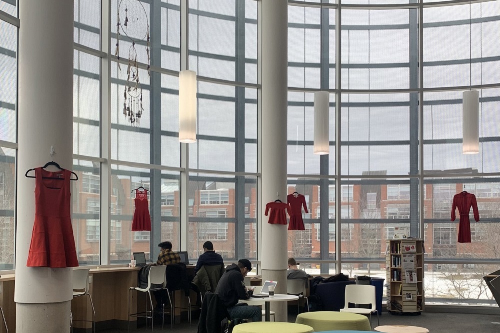 Red dresses displayed in Ontario Tech University's North Oshawa Campus Library.