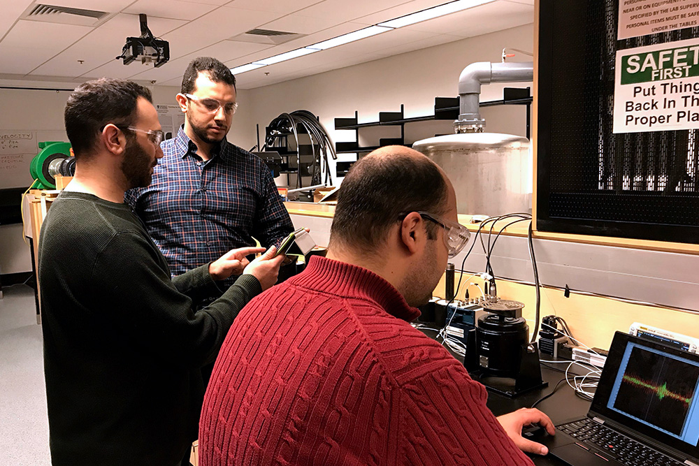 From left: Mohammed Alziadeh (Ontario Tech PhD candidate) discusses seismic test results with Mahmoud Shaaban, PhD (Ontario Tech doctoral fellow) while Omar Sadek (Ontario Tech PhD candidate, seated) takes a sample measurement. 