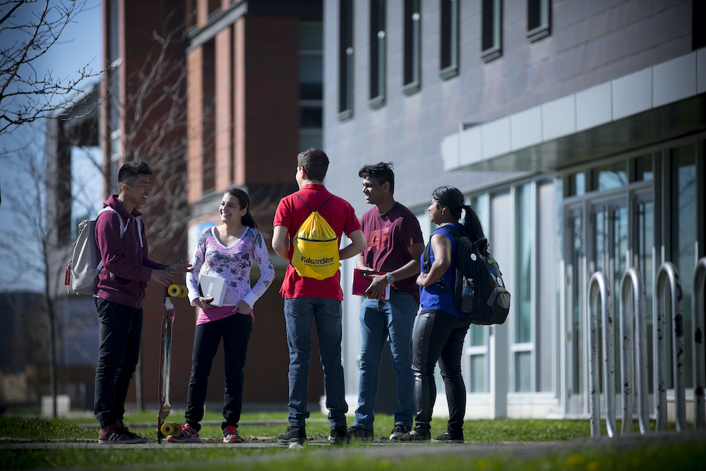 Students talking in front of Ontario Tech University building