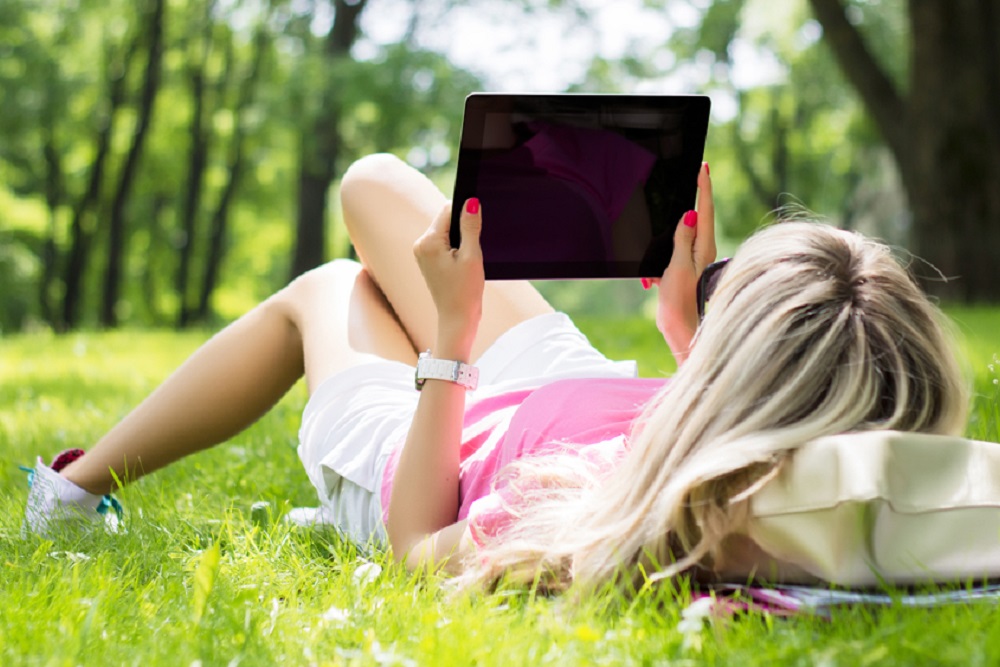 Student outdoors with laptop
