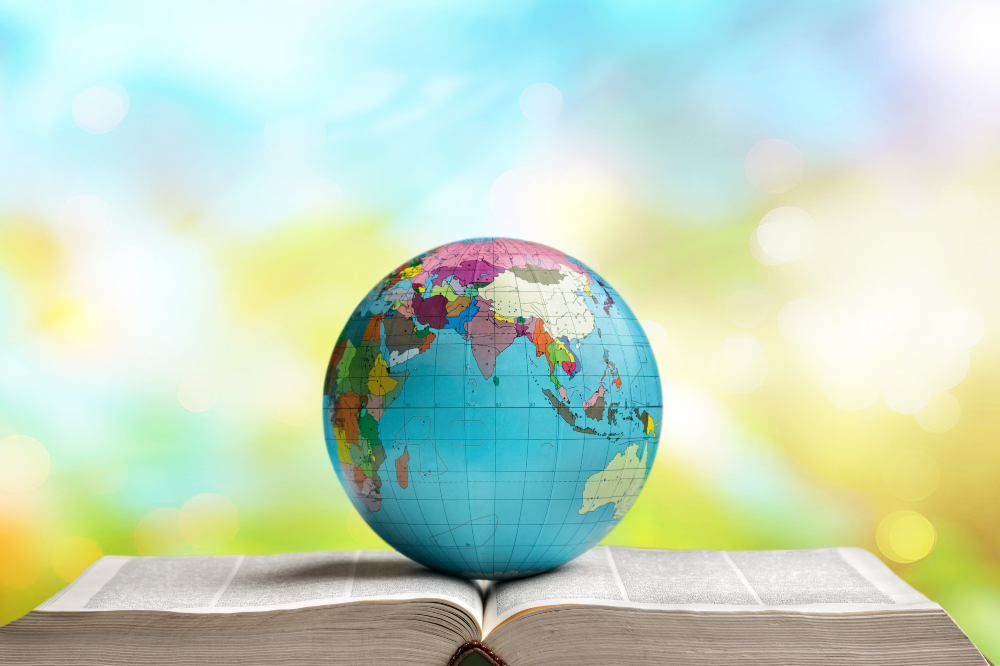 Globe sitting on top of a book, depicting international studies