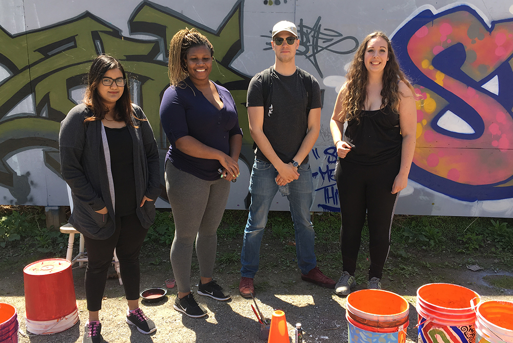 Pre-pandemic image of Ontario Tech students doing community development work with Faculty of Social Science and Humanities community partner LivingRoom Community Art Studio.  