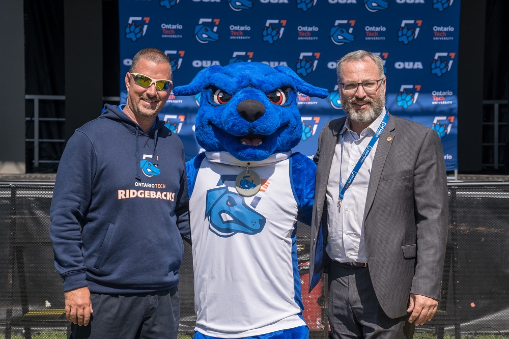 From left: Ontario Tech's Scott Barker, Director, Athletics, with university mascot Hunter the Ridgeback and Dr. Steven Murphy, President and Vice-Chancellor.
