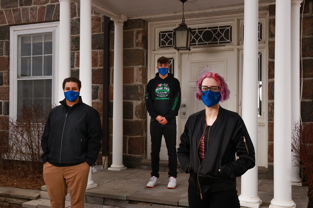 In front of the Stone House on Simcoe Street North, Oshawa. From left: Tribute Communities Success Scholarship recipients Samuel Berzi (Health Sciences), Michael Novielli (Kinesiology) and Dayna Risebrough (Forensic Science).