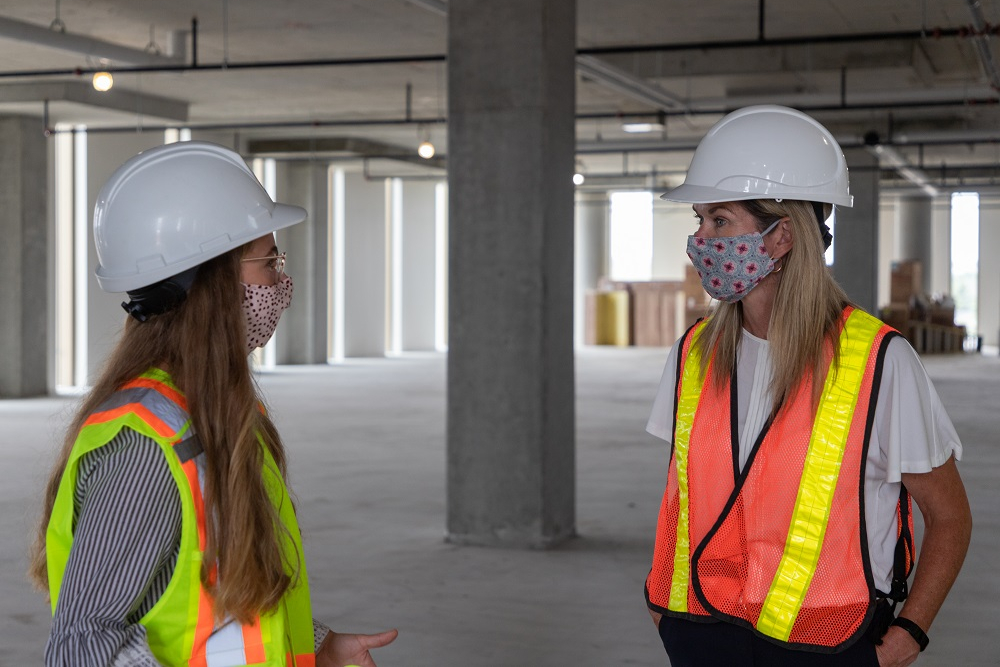 From left: Alana Waloszek, Health Sciences (Public Health) student at Ontario Tech, speaks with the Honourable Jill Dunlop, Ontario Minister of Colleges and Universities, during a tour of Ontario Tech’s newest building, Shawenjigewining Hall.