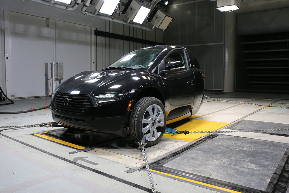 Dynamic testing of the three-wheel Electra Meccanica Solo EV in the ACE Climatic Wind Tunnel at Ontario Tech University. The one-person electric vehicle has two front wheels and one rear wheel.