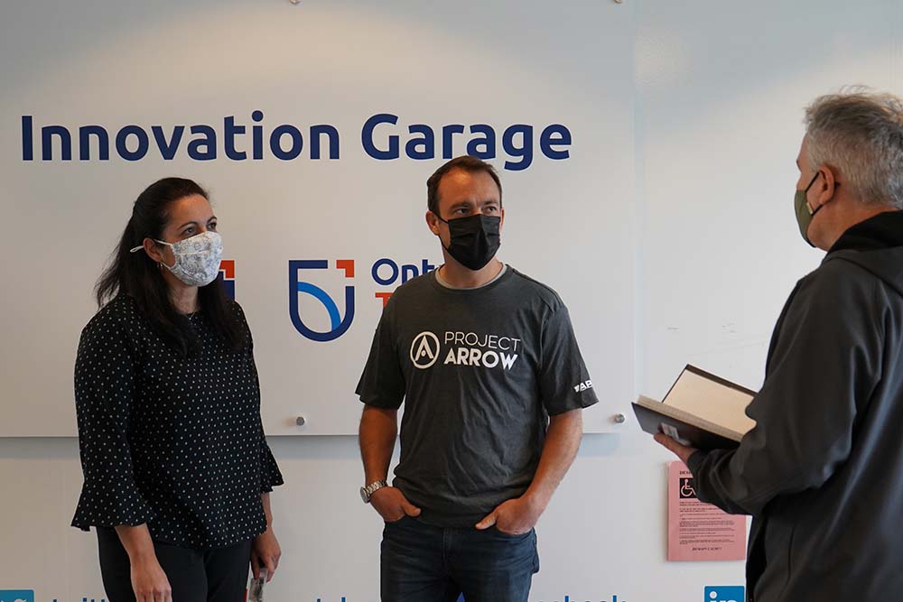 Fraser Dunn, Chief Engineer, Project Arrow (centre), with Paula Ambra, ACE Project Manager (left) at the ACE Innovation Garage, Ontario Tech University.