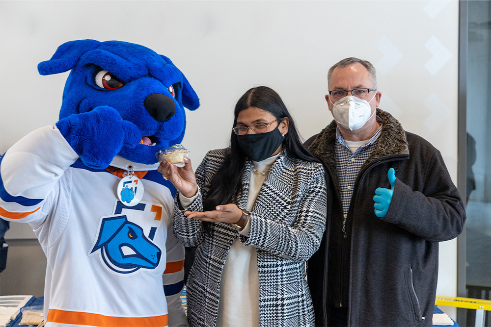 Ontario Tech on-campus Pi Day Pie Party at Shawenjigewining Hall: Hunter the Ridgeback with Amrutha Elanko, Vice-President Ontario Tech Student Union (centre) and Dr. Steven Murphy, President and Vice-Chancellor (March 14, 2022).