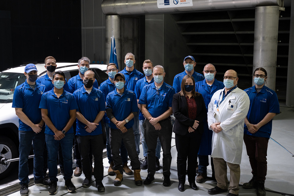 ACE staff next to the new Moving Ground Plane inside the Climatic Wind Tunnel.