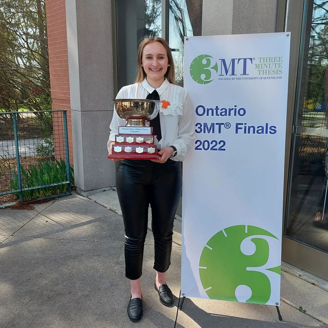 Emmeline Meens Miller, 2022 Ontario Three Minute Thesis champion with the 3MT first-place trophy.