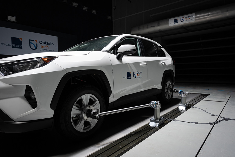 Vehicle being tested for dynamic response on the Moving Ground Plane (grey/silver belt underneath vehicle) inside the ACE Climatic Wind Tunnel.