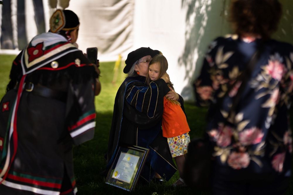 Phyllis (Jack) Webstad, Founder of Orange Shirt Day, greets a youngster after her honorary degree ceremony at Ontario Tech's Convocation in June 2022.