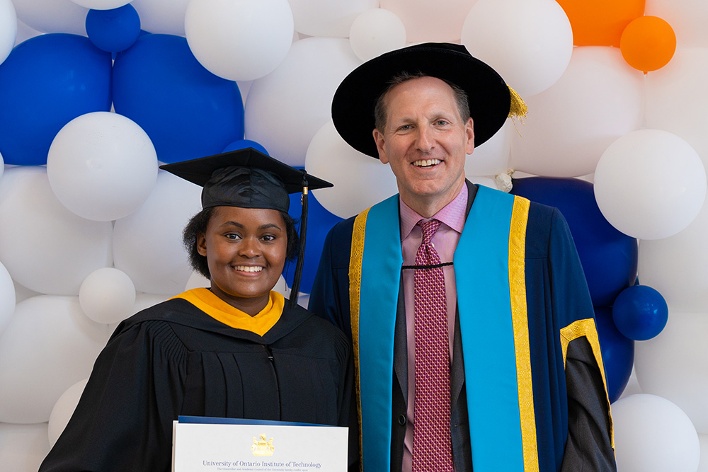 Chancellor Mitch Frazer (right), with Kgalalelo Rampete, graduate of Ontario Tech University's Forensic Science program, at the university's Convocation ceremonies in June 2022.