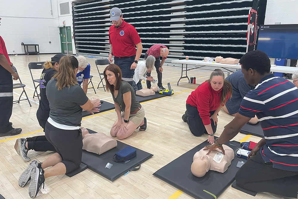 Community members practice chest compressions in the adult phase of the CPR training (June 22, 2023).
