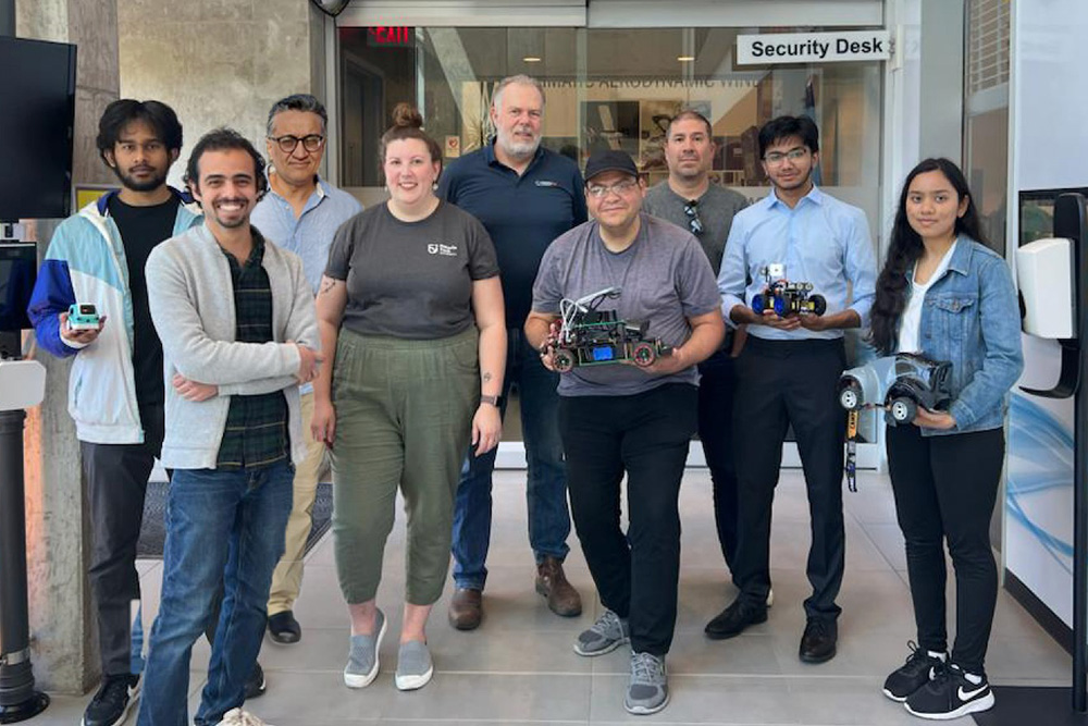 Ontario Tech University's Regional Future Workforce project team, led by Dr. Mohamed El-Darieby (Faculty of Engineering and Applied Science; third from left) and Dr. Roland van Oostveen (Faculty of Education; fifth from left). Image taken at the entrance to Ontario Tech's ACE Core Research Facility.