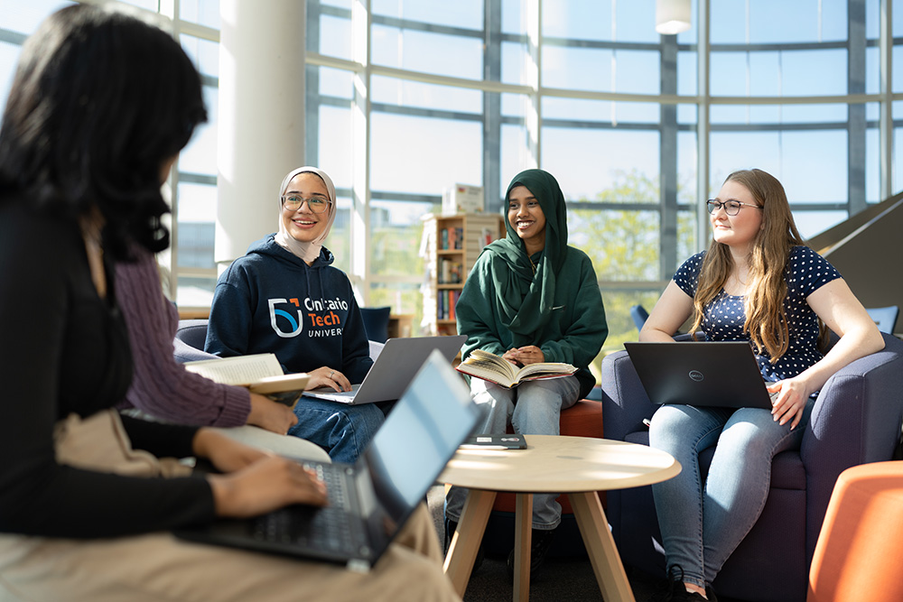 image of Ontario Tech students in the Dixon-Alger Fireside Reading Room in the Campus Library at the university's north Oshawa location.