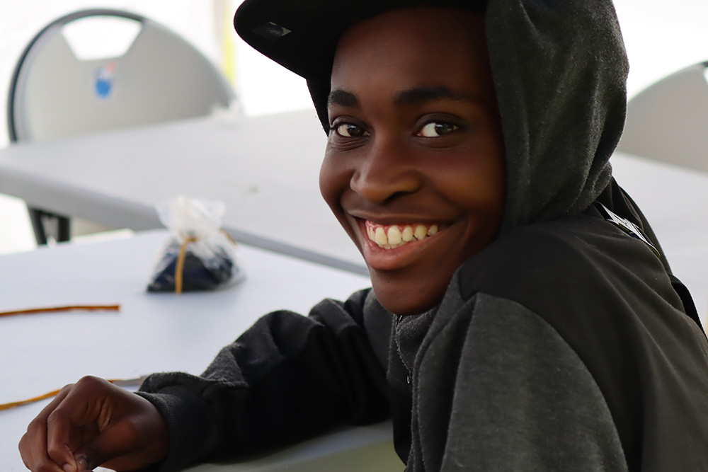 Participant at Ontario Tech University Engineering Outreach's first InSTEM Land Camp program in an ‘energy beading’ activity (simulating consumption of renewable and non-renewable energy sources). 