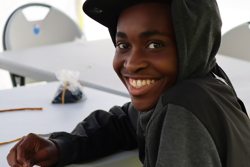 Participant at Ontario Tech University Engineering Outreach's first InSTEM Land Camp program in an ‘energy beading’ activity (simulating consumption of renewable and non-renewable energy sources).