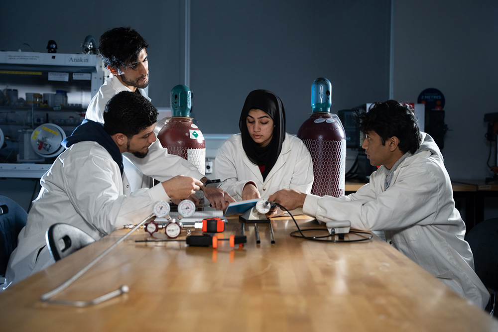 Ontario Tech Engineering students consulting in a laboratory in the university's Energy Research Centre.
