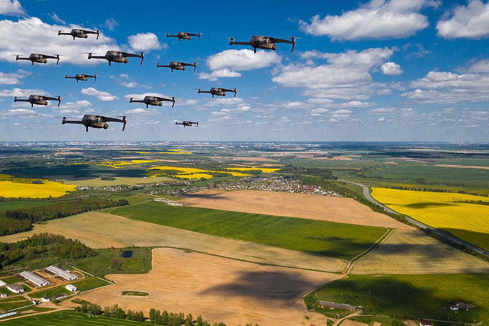 image of cluster of drones flying over an agricultural landscape