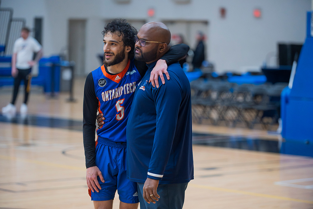 image of Fourth-year Ridgebacks men's basketball player Zubair Seved (left) with men's basketball Head Coach Deluxshan Pathmanathan.