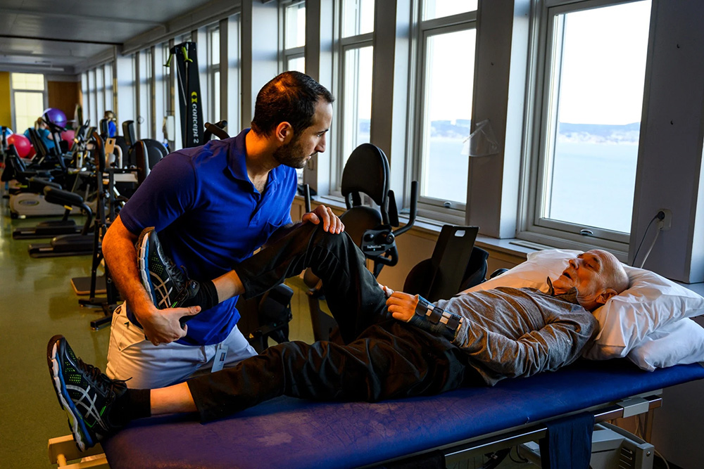 Patient receiving rehabilitation care and treatment at a health-care centre in Norway (photo credit: WHO).