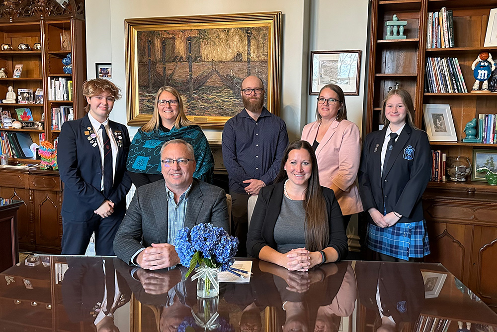 Dr. Steven Murphy, President and Vice-Chancellor, Ontario Tech University (front left) and Melissa Knight-Johnson, Head of School, Trafalgar Castle School (front right) sign partnership agreement (November 19, 2024).