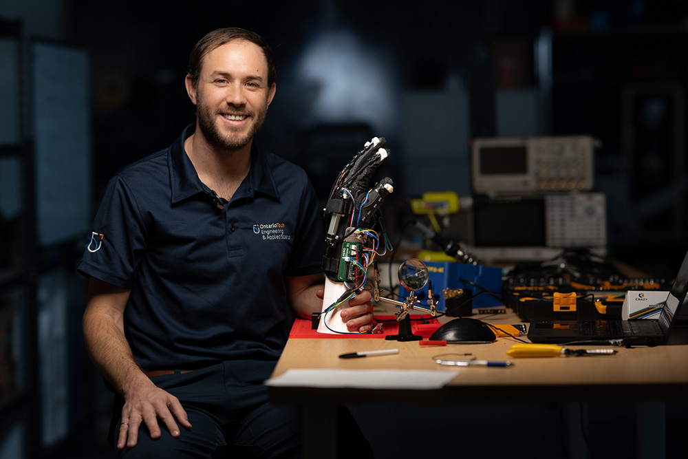 Dr. Aaron Yurkewich with the HERO Glove in the Ontario Tech University BioRobotics Lab.