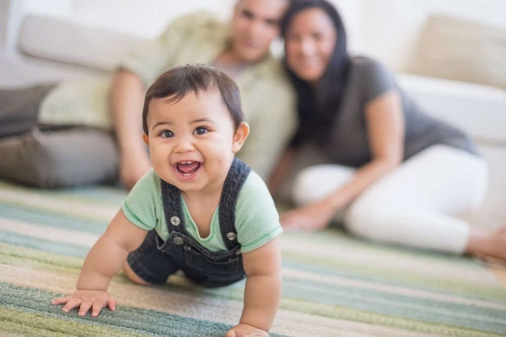 Baby in foreground with parents in background