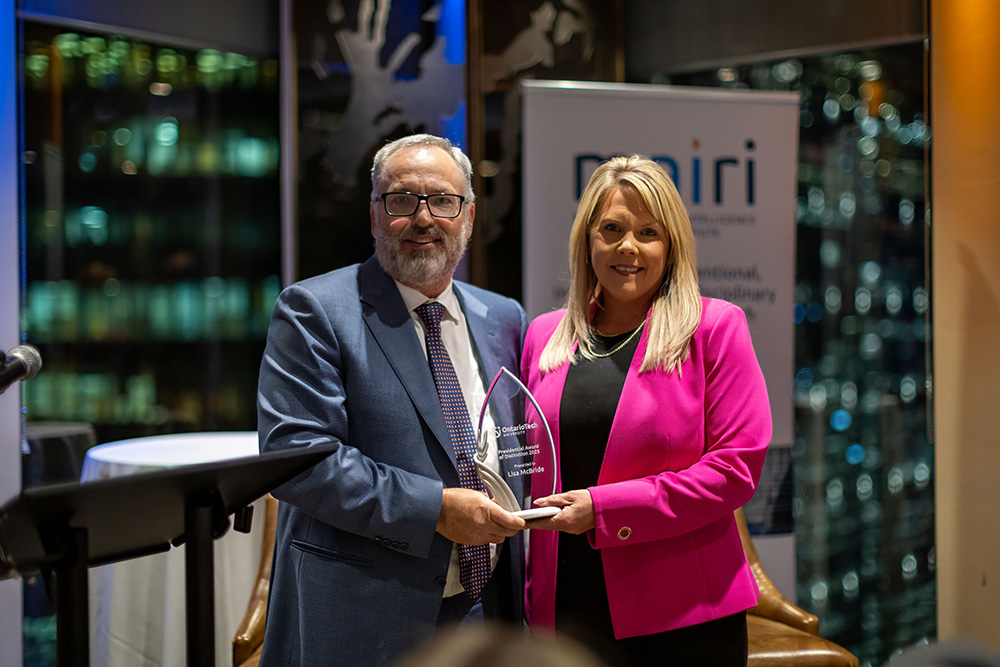 President Dr. Steven Murphy presents the Presidential Award of Distinction to Lisa McBride