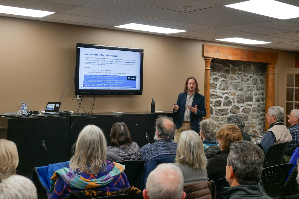 At an Uxbridge Public Library educational event, Dr. Peter Lewis, Canada Research Chair in Trustworthy AI and Associate Professor in Ontario Tech University’s Faculty of Business and Information Technology, explains the ‘stochastic parrot’ metaphor to participants.
