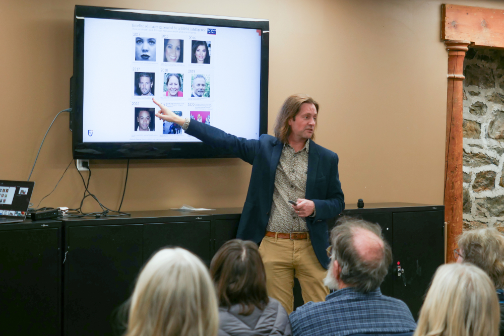 Dr. Peter Lewis, Canada Research Chair in Trustworthy AI and Associate Professor in Ontario Tech University’s Faculty of Business and Information Technology, shares examples of AI-generated images with participants at an Uxbridge Public Library educational event.