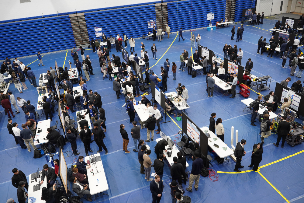 Overhead shot of the 2026 Engineering Capstone Systems Design Exhibition and Competition in the gymnasium, Campus Recreation and Wellness Centre, Ontario Tech University north campus.