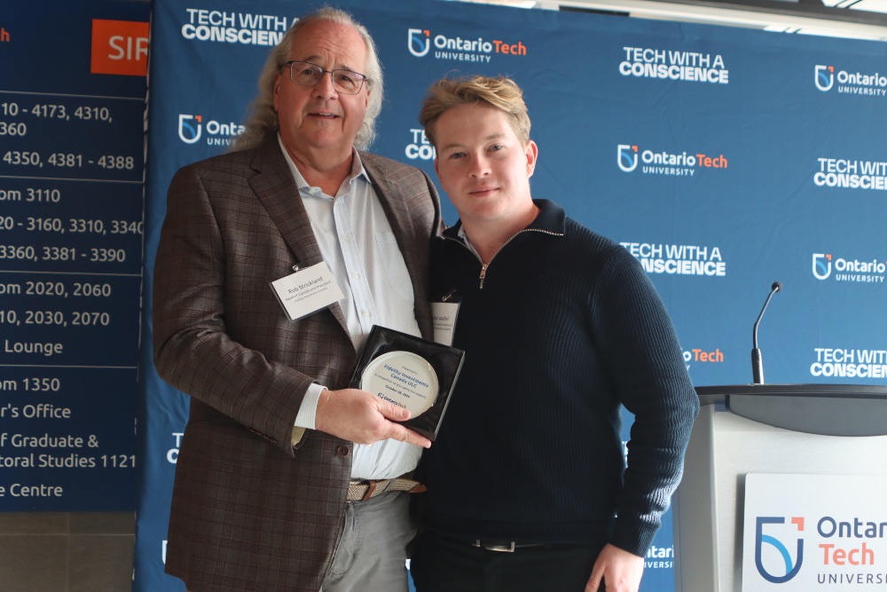 From left: Rob Strickland, Head of Fidelity Investments Canada, and Aidan Waddell, third-year Networking and IT Security student at Ontario Tech University, celebrate Fidelity Investments Canada’s $100,000 gift supporting cybersecurity research and student scholarships.